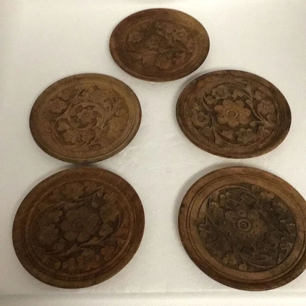 Set a five hand carved wooden floral coasters